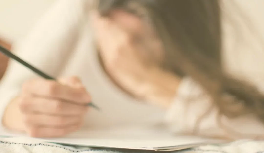 Woman writing affirmations to overcome fear